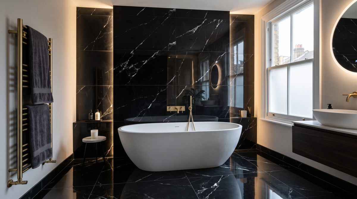Onyx Black Marble Effect Polished Porcelain 60x120cm wall and floor tiles installed with 2mm rectified black grout joints in a luxury UK bathroom with freestanding white bath and brushed brass fixtures