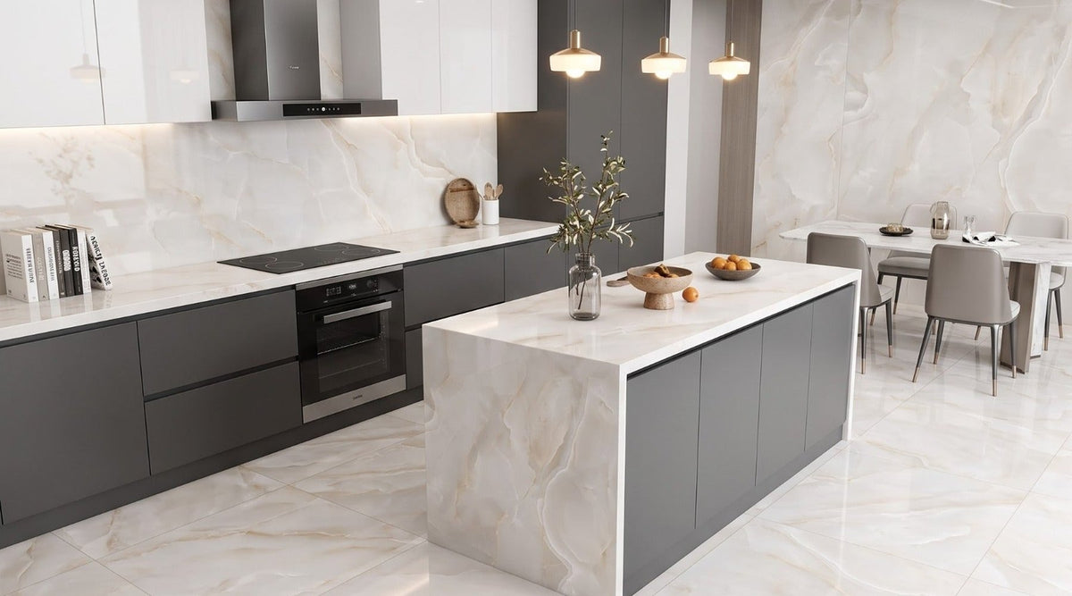 Onyx Diora Gold 60x120cm polished porcelain on a kitchen floor, splashback and waterfall island with charcoal grey cabinets