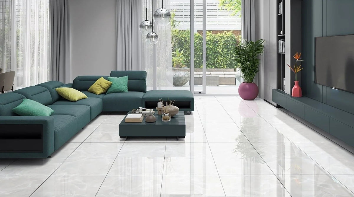 Onyx White polished porcelain floor tiles in a bright open-plan living room with a teal sofa and garden doors