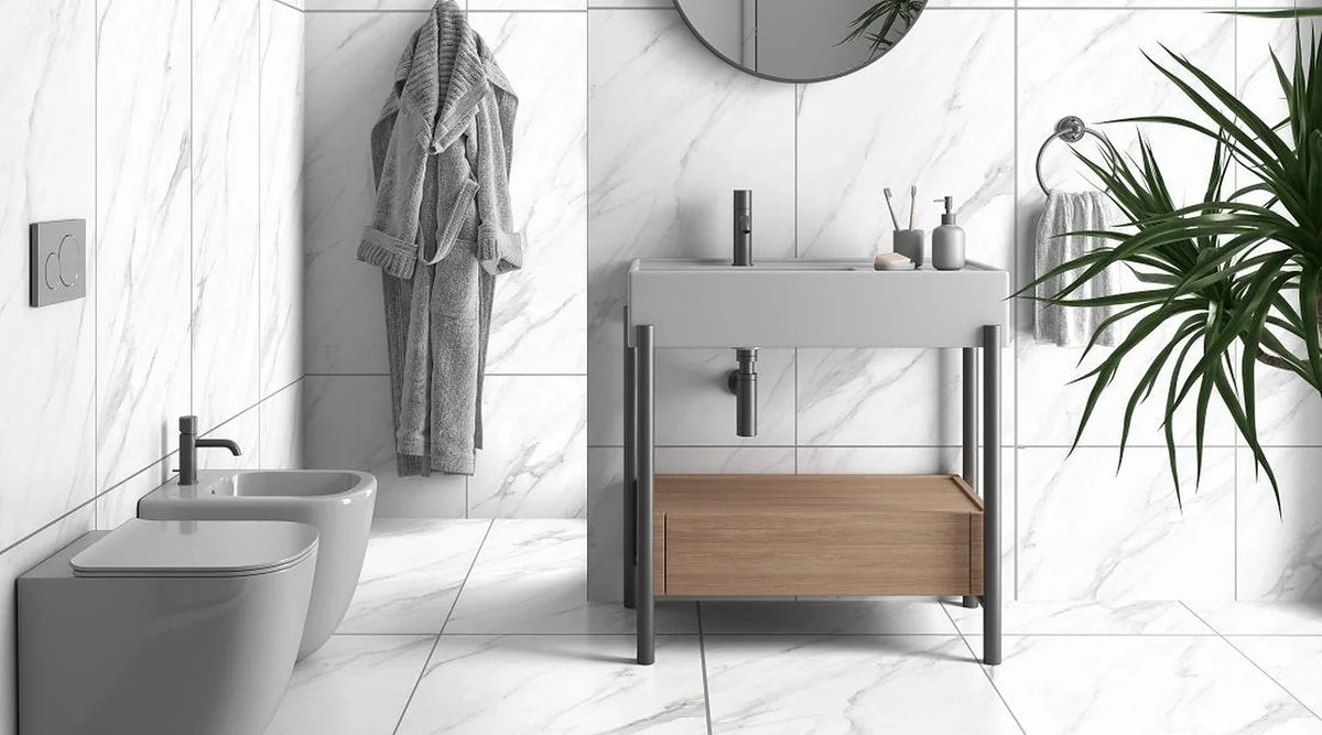Statuario Carrara White matt anti-slip marble effect porcelain on a bathroom floor and walls with grey back-to-wall sanitaryware and an oak washstand