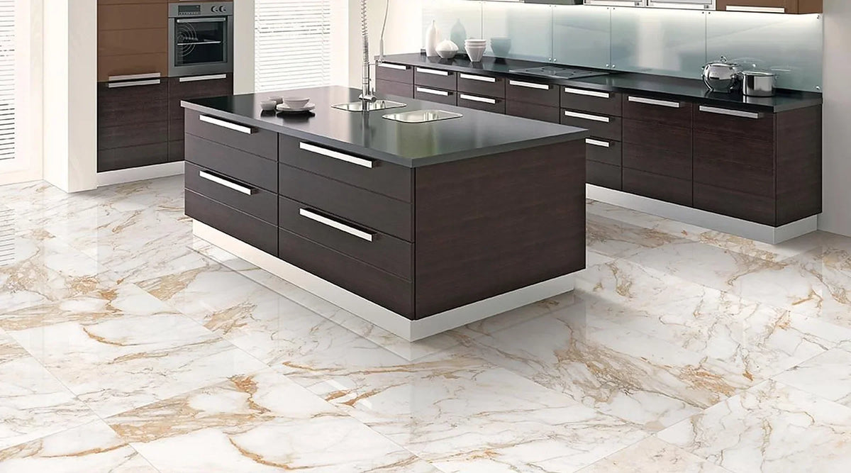 White marble effect polished porcelain floor tiles with gold veins in a modern kitchen with dark wood island