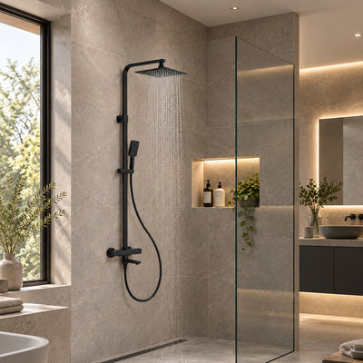Quadra matt black exposed thermostatic bath shower mixer in a walk-in shower with beige stone-effect tiles