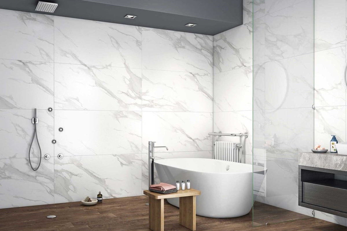 Side-by-side comparison of 60x120cm Statuario Mercury Grey high-gloss polished porcelain tile and R11 matt anti-slip porcelain tile showing specular light reflection versus micro-textured wet-grip surface
